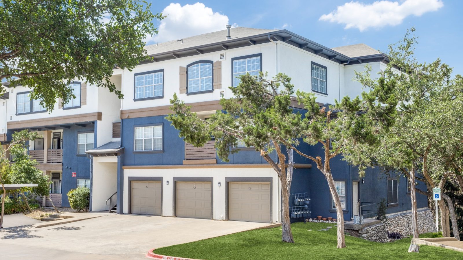 the exterior of a two story apartment building at The Ellwood at Lake Travis