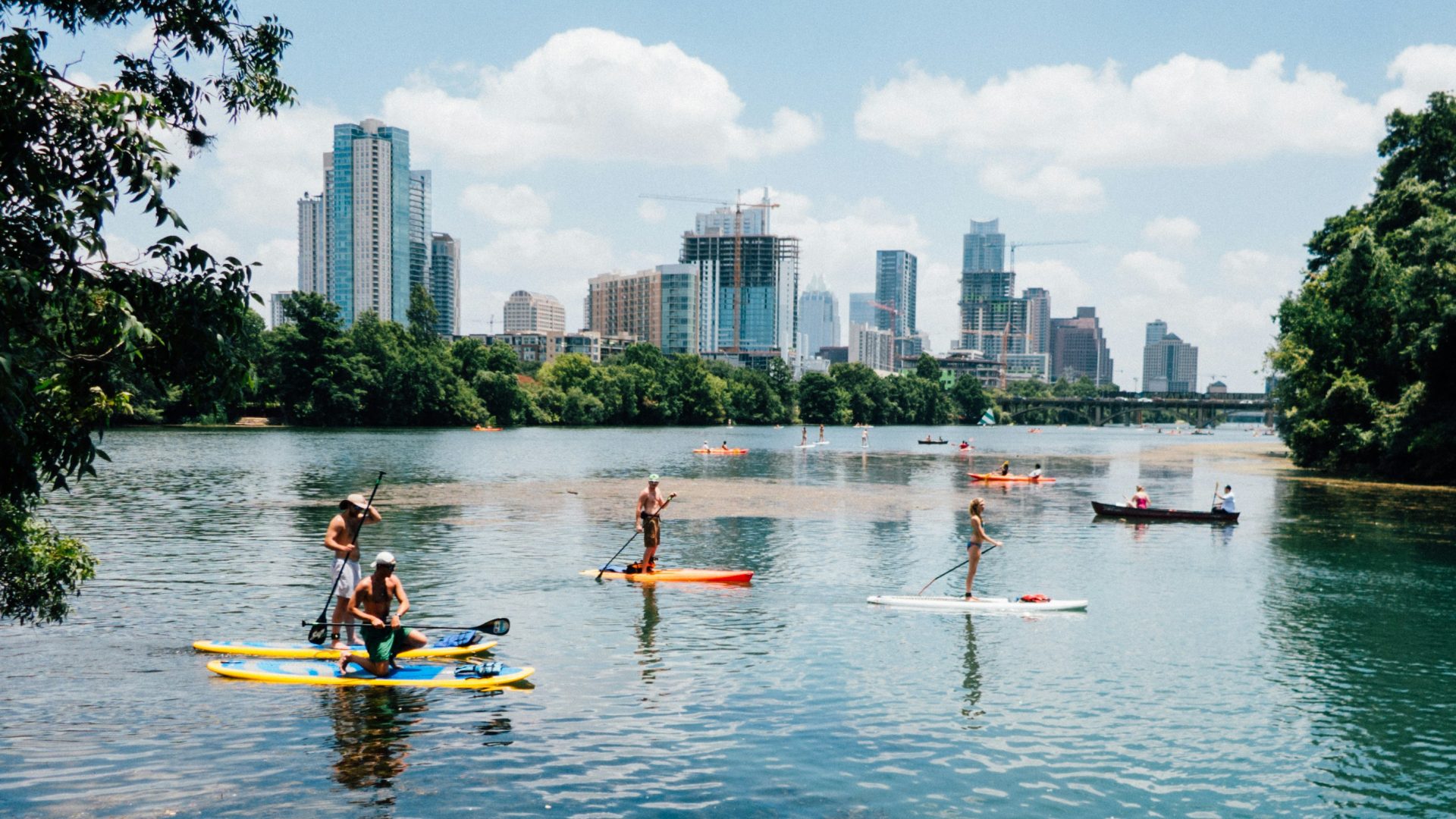 people riding paddle boards on the lake